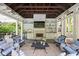 Comfortable outdoor living space with fireplace, bar area, and comfortable seating at 9080 Pickwick Dr, Indianapolis, IN 46260