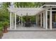 Covered patio with an outdoor dining table, lounge chairs, grill and fireplace by the pool at 9080 Pickwick Dr, Indianapolis, IN 46260