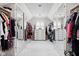 Spacious walk-in closet featuring ample hanging space and mirrored doors at 9080 Pickwick Dr, Indianapolis, IN 46260