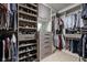 Well-organized walk-in closet featuring shelves and drawers for shoes and clothing at 9080 Pickwick Dr, Indianapolis, IN 46260