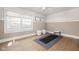 Serene yoga room with hardwood floors, neutral walls, and soft lighting, ideal for relaxation and meditation at 9080 Pickwick Dr, Indianapolis, IN 46260