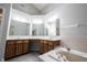 Bathroom featuring double sink vanity, built-in tub, and a glass enclosed shower at 9303 Aintree Dr, Indianapolis, IN 46250