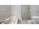 Bright bathroom featuring a soaking tub and a separate glass-enclosed shower at 9303 Aintree Dr, Indianapolis, IN 46250