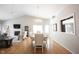 Inviting dining room with hardwood floors, chandelier, and views into the living space and fireplace at 9303 Aintree Dr, Indianapolis, IN 46250