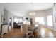 Open-concept dining area featuring a chandelier and wood floors, perfect for Gathering gatherings at 9303 Aintree Dr, Indianapolis, IN 46250