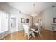 Lovely dining room with hardwood floors and chandelier, adjacent to other living spaces in the home at 9303 Aintree Dr, Indianapolis, IN 46250