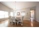 Bright dining room with stylish chandelier, neutral decor, and wood floors at 9303 Aintree Dr, Indianapolis, IN 46250