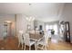 Spacious dining room with hardwood floors and view into living room with fireplace and comfortable seating at 9303 Aintree Dr, Indianapolis, IN 46250