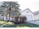 Charming single-Gathering home featuring white siding, attached garage, and a lovely landscaped front yard at 9303 Aintree Dr, Indianapolis, IN 46250