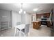 Eat-in kitchen with stainless steel appliances, wooden cabinets, and tile floors at 9303 Aintree Dr, Indianapolis, IN 46250