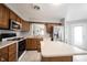 Updated kitchen with wood cabinets, stainless steel appliances, and a cozy breakfast bar at 9303 Aintree Dr, Indianapolis, IN 46250