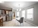 Eat-in kitchen with stainless steel refrigerator, tile floors, and table with gray chairs at 9303 Aintree Dr, Indianapolis, IN 46250