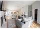 Open-concept living room with a fireplace, wood floors, and neutral decor at 9303 Aintree Dr, Indianapolis, IN 46250