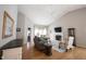 Open-concept living room featuring a fireplace, vaulted ceiling, and wood floors at 9303 Aintree Dr, Indianapolis, IN 46250