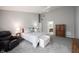 Comfortable main bedroom featuring neutral walls, carpet, a seating area, and adjoining bathroom at 9303 Aintree Dr, Indianapolis, IN 46250