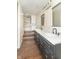 Updated bathroom with double vanity, dark cabinets, quartz counters, and a new tiled shower at 953 S 5Th St, Noblesville, IN 46060