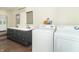 Updated bathroom includes a laundry setup, double vanity, dark cabinets, quartz counters and new fixtures at 953 S 5Th St, Noblesville, IN 46060