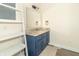 Bathroom featuring a blue vanity with granite countertop and ladder shelving for storage at 953 S 5Th St, Noblesville, IN 46060