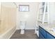 Cozy bathroom featuring a blue vanity, granite countertop, and shower-tub combination at 953 S 5Th St, Noblesville, IN 46060