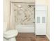 Updated bathroom features a new tiled shower with a rainfall shower head and a built-in cabinet at 953 S 5Th St, Noblesville, IN 46060