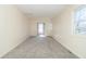 Bright bedroom with neutral walls, plush carpeting, and natural light from two windows at 953 S 5Th St, Noblesville, IN 46060