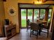 Charming breakfast nook features a round table with seating and large windows offering backyard views at 953 S 5Th St, Noblesville, IN 46060