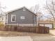 Well-maintained home exterior features neutral siding, a wooden fence, and an oversized garage at 953 S 5Th St, Noblesville, IN 46060