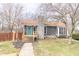 Charming one-story home featuring a stone chimney, teal front door, and wooden steps leading to the entrance at 953 S 5Th St, Noblesville, IN 46060