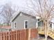 Cozy home exterior with neutral siding, well-kept landscaping, and a classic wooden fence at 953 S 5Th St, Noblesville, IN 46060