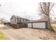 A view of the home's exterior featuring a large two-car garage and wooden fence at 953 S 5Th St, Noblesville, IN 46060