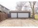 Spacious detached two-car garage with white doors and a wide driveway for additional parking at 953 S 5Th St, Noblesville, IN 46060