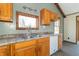 Kitchen featuring stainless steel sink, laminate counters, wood cabinetry, and modern fixtures at 953 S 5Th St, Noblesville, IN 46060