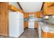 Functional kitchen with wood cabinetry, neutral countertops, and standard white appliances at 953 S 5Th St, Noblesville, IN 46060