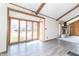 Sun-drenched sun room features a wall of windows and sleek flooring and adjacent fireplace wall at 953 S 5Th St, Noblesville, IN 46060