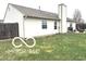 Backyard view featuring an outdoor green space and tall chimney at 1001 Maple W Dr, Lebanon, IN 46052
