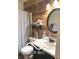 Bathroom featuring an accent wall, an oval mirror, toilet, sink, and a bathtub with shower at 1001 Maple W Dr, Lebanon, IN 46052