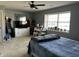 Bright bedroom with a large window, neutral paint, and a dresser with a mounted flatscreen TV at 1001 Maple W Dr, Lebanon, IN 46052