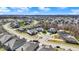 High angle aerial view of a neighborhood featuring well-maintained homes nestled among trees, roads, and landscaping at 11072 Song Creek Ct, Fishers, IN 46040