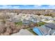 An aerial view of a neighborhood showcasing various homes and the surrounding landscape at 11072 Song Creek Ct, Fishers, IN 46040