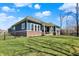 Backyard showcases vibrant blue siding, brick accents, and a cozy covered patio at 11072 Song Creek Ct, Fishers, IN 46040