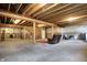 Spacious unfinished basement with exposed beams and ductwork, offering potential for customization at 11072 Song Creek Ct, Fishers, IN 46040