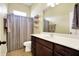 Bright bathroom featuring vanity, toilet, and tiled shower with curtain at 11072 Song Creek Ct, Fishers, IN 46040