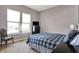Well-lit bedroom featuring two windows and a comfortable-looking plaid bedspread at 11072 Song Creek Ct, Fishers, IN 46040