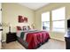 Inviting bedroom with bright windows, lamps, and decorative bed at 11072 Song Creek Ct, Fishers, IN 46040