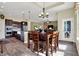 Open concept dining area with a dark wood table, adjacent to a modern kitchen at 11072 Song Creek Ct, Fishers, IN 46040
