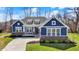 Charming blue, single-Gathering home with brick accents, manicured lawn and three dormer windows at 11072 Song Creek Ct, Fishers, IN 46040