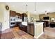 Modern kitchen boasts stainless steel appliances, a farmhouse sink, and a view into the living room at 11072 Song Creek Ct, Fishers, IN 46040