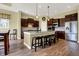 Beautiful kitchen features dark cabinets, stainless steel appliances, and a large island with seating at 11072 Song Creek Ct, Fishers, IN 46040