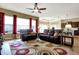 Open living space with hardwood floors, cozy seating, and an adjacent kitchen area at 11072 Song Creek Ct, Fishers, IN 46040