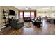Open living room with hardwood floors, comfortable seating, and a view into the kitchen at 11072 Song Creek Ct, Fishers, IN 46040